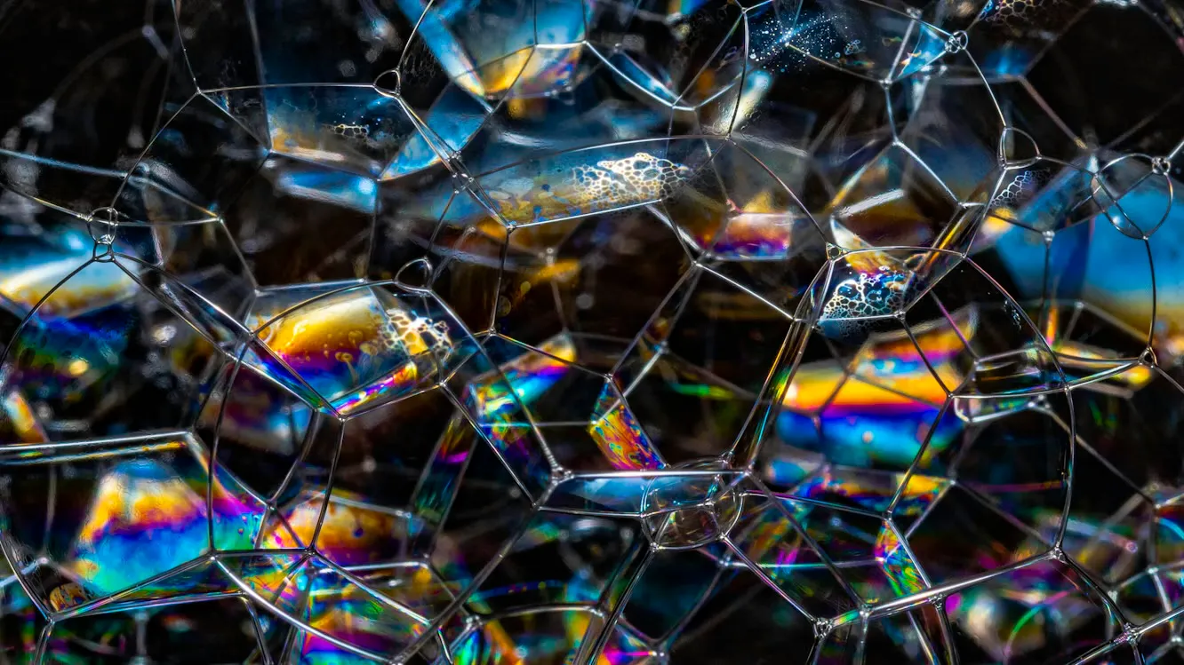 Colorful bubbles colliding together to form distinct parts of an otherwise incoherent structure.